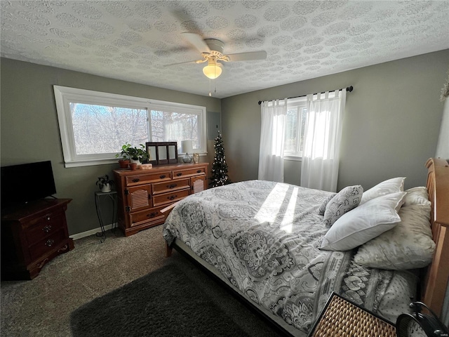 bedroom with carpet floors, ceiling fan, baseboards, and a textured ceiling