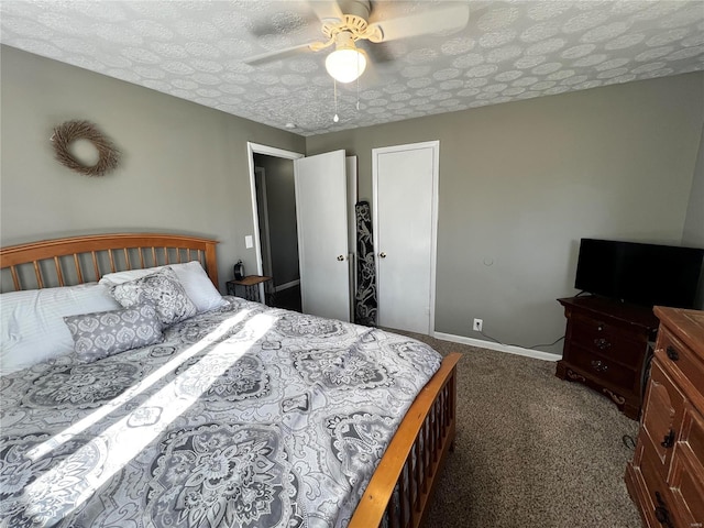 bedroom with a ceiling fan, dark carpet, a textured ceiling, and baseboards