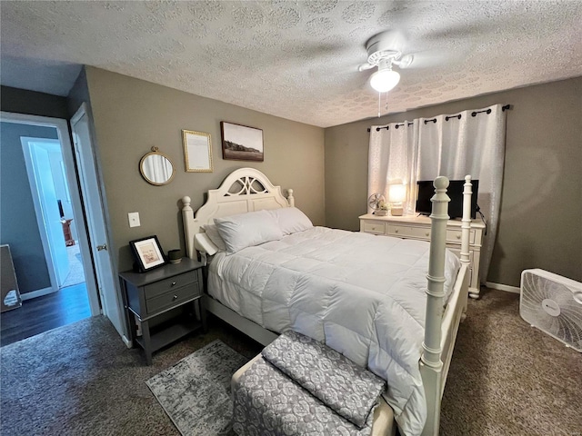 bedroom with a textured ceiling, dark colored carpet, a ceiling fan, and baseboards