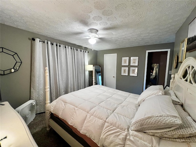 carpeted bedroom featuring ceiling fan and a textured ceiling