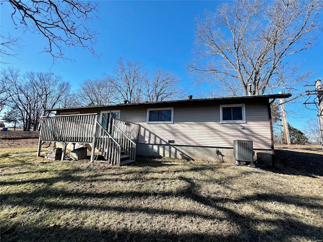 back of property featuring stairs, a lawn, and a wooden deck