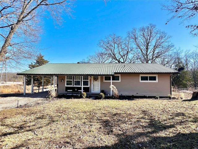 view of front of home featuring metal roof and an attached carport