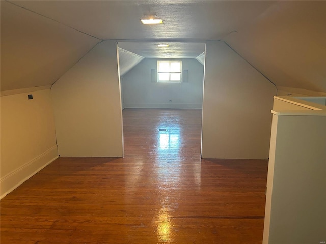 bonus room featuring lofted ceiling and wood finished floors