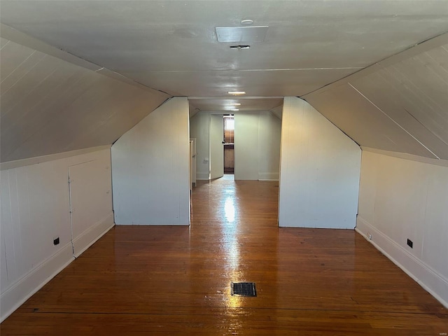 bonus room with lofted ceiling, visible vents, and wood finished floors