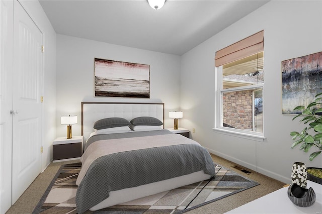 bedroom with carpet flooring, visible vents, and baseboards