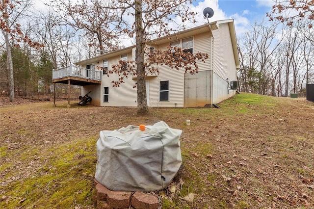 rear view of property with a lawn and a deck