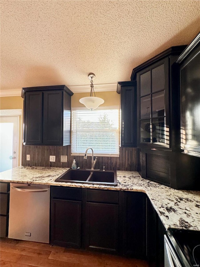 kitchen with dishwasher, ornamental molding, range with electric stovetop, wood finished floors, and a sink