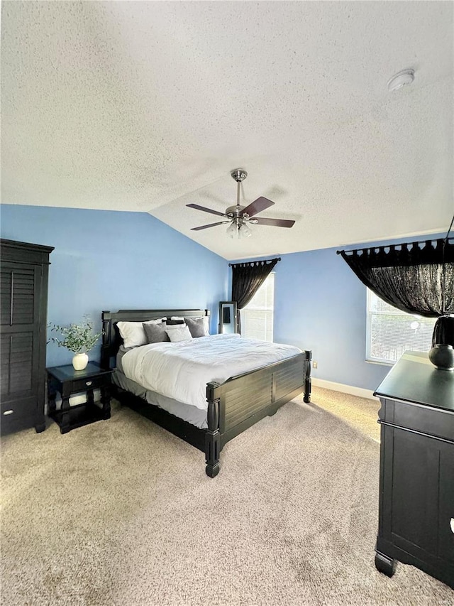 carpeted bedroom featuring baseboards, ceiling fan, a textured ceiling, and lofted ceiling