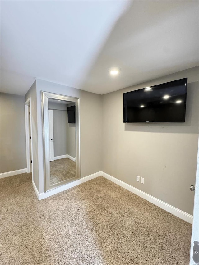 unfurnished bedroom with a closet, baseboards, and carpet