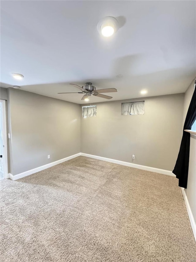 interior space with baseboards, carpet floors, and ceiling fan