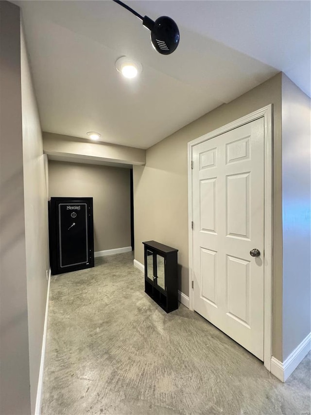 below grade area featuring baseboards and carpet floors