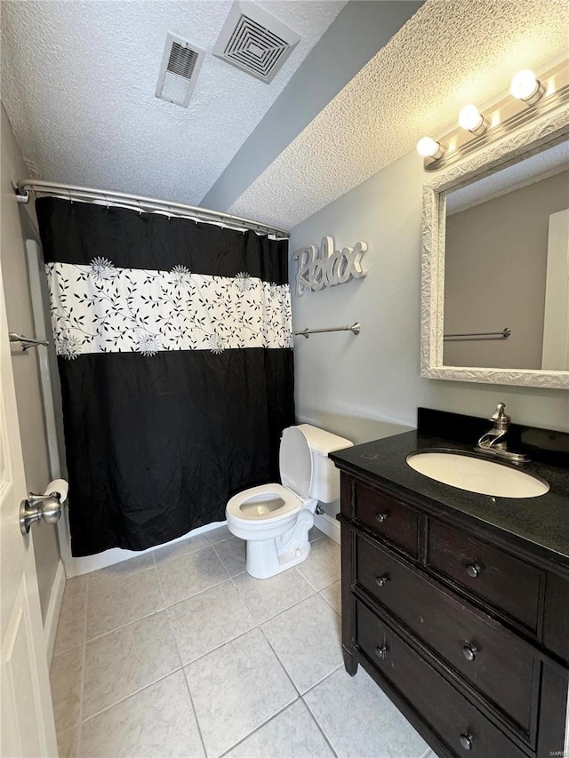 bathroom featuring vanity, visible vents, tile patterned flooring, a textured ceiling, and toilet