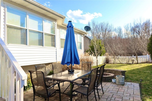 view of patio featuring outdoor dining space and fence