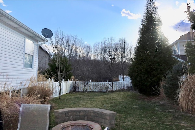 view of yard with an outdoor fire pit and fence