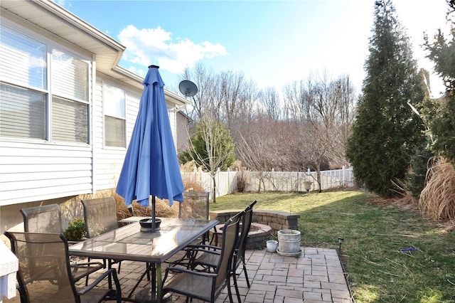 view of patio featuring outdoor dining space and fence