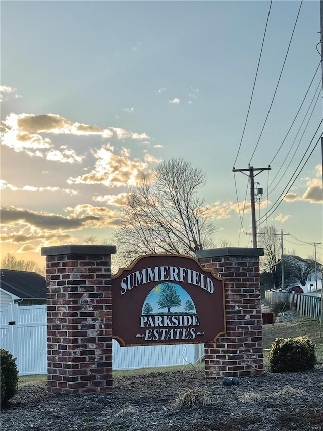 community / neighborhood sign with fence