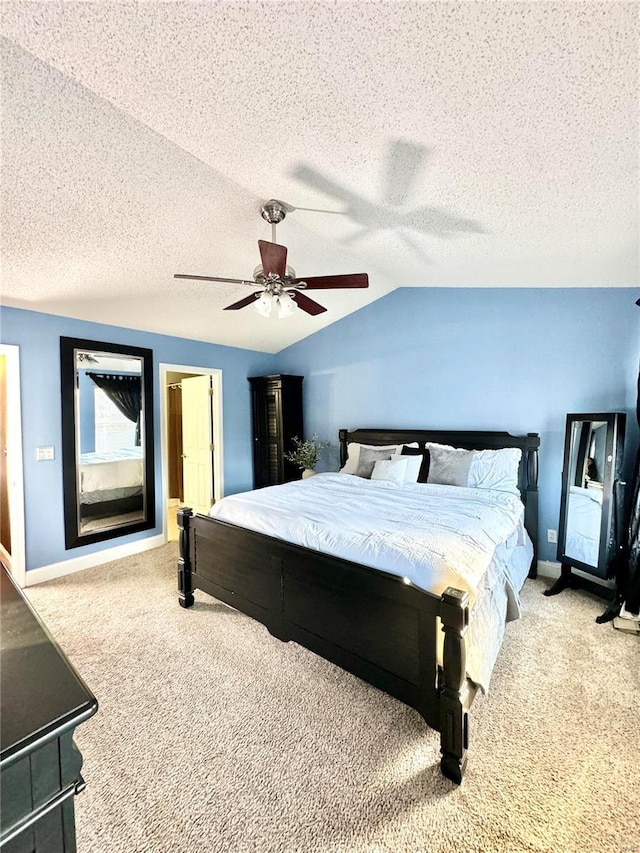 carpeted bedroom with baseboards, a textured ceiling, a ceiling fan, and lofted ceiling