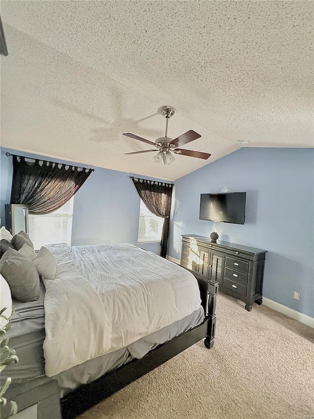 bedroom with baseboards, ceiling fan, light colored carpet, lofted ceiling, and a textured ceiling