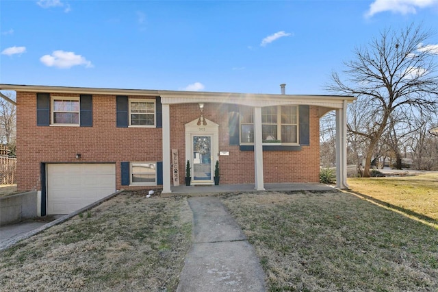 view of front facade featuring brick siding, a garage, and a front lawn