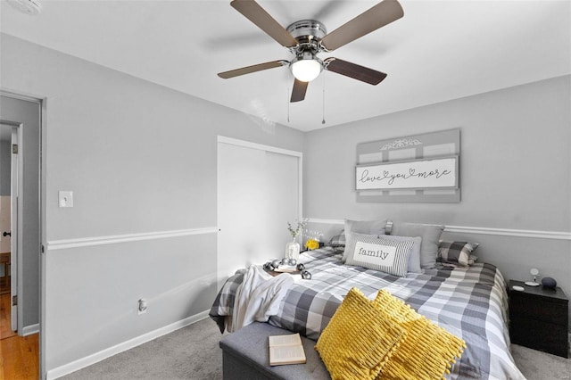 bedroom featuring a closet, baseboards, ceiling fan, and carpet flooring