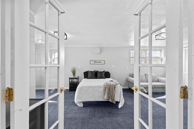 bedroom featuring french doors, dark colored carpet, and baseboards