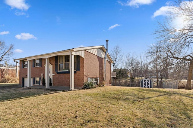 view of side of home featuring brick siding, a storage shed, a yard, and fence