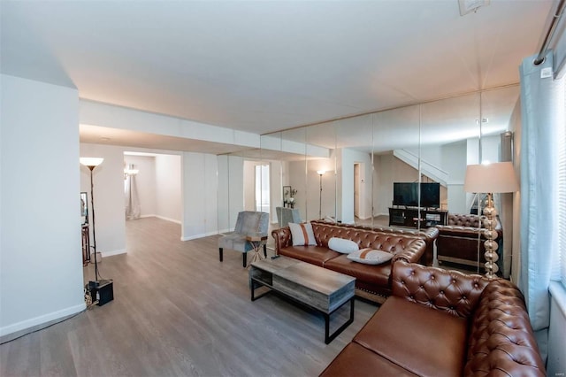 living area with wood finished floors and baseboards