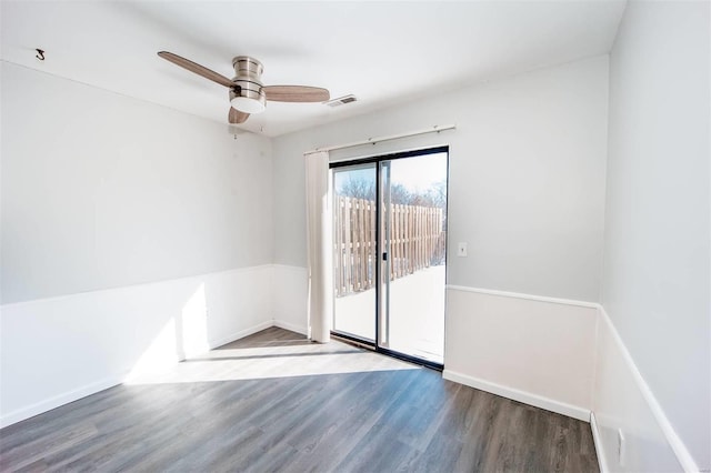 unfurnished room with baseboards, visible vents, ceiling fan, and wood finished floors