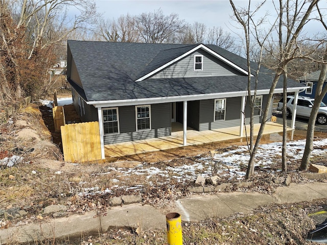 view of front of home with a shingled roof and a porch