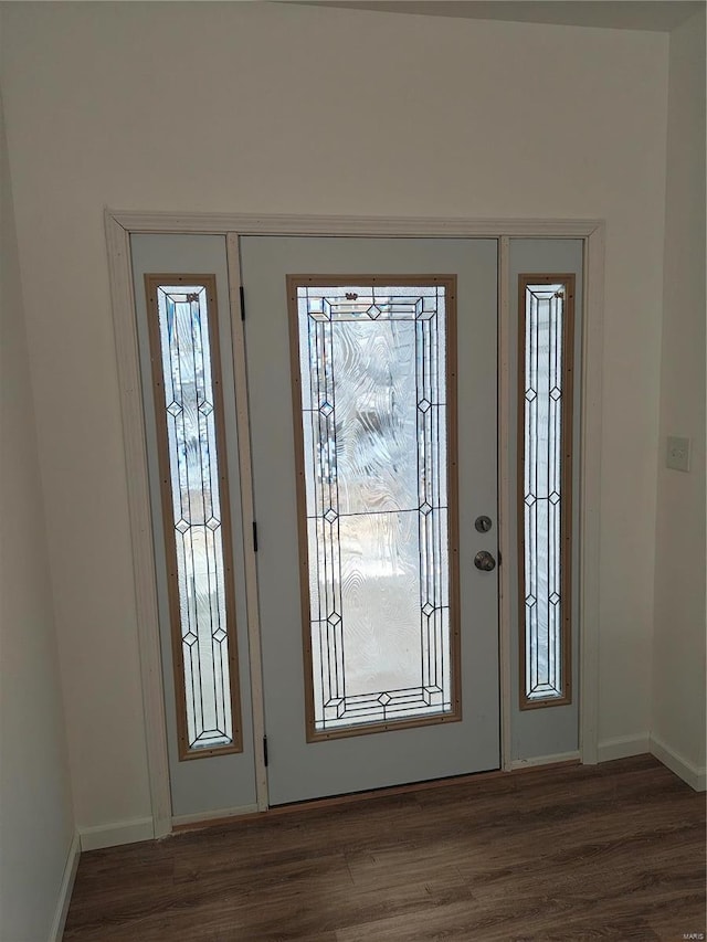 foyer entrance featuring plenty of natural light, wood finished floors, and baseboards