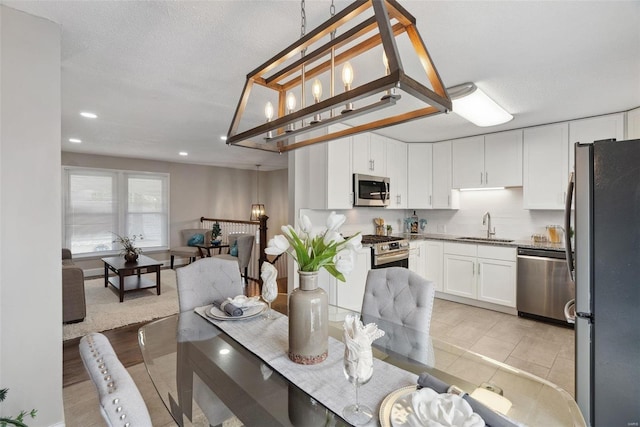 dining space featuring a textured ceiling and recessed lighting