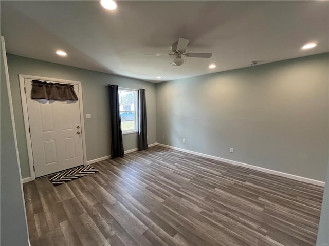 empty room featuring recessed lighting, dark wood finished floors, and baseboards