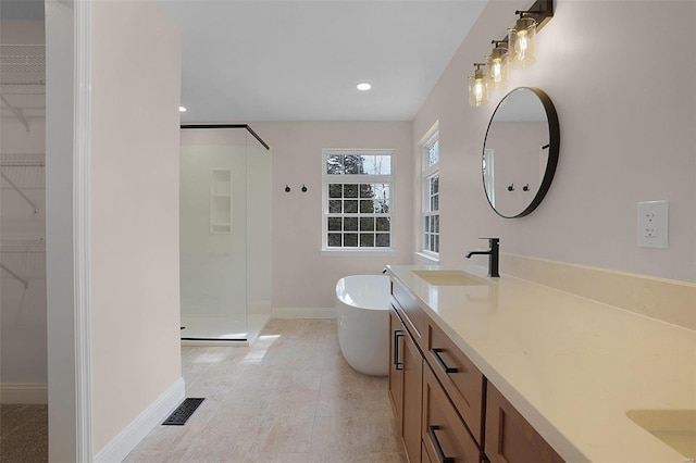 bathroom featuring double vanity, a soaking tub, visible vents, a sink, and a shower stall