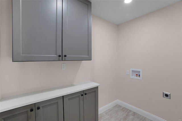 laundry area featuring cabinet space, hookup for a washing machine, baseboards, and hookup for an electric dryer