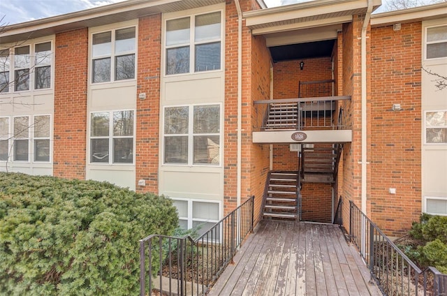 doorway to property featuring brick siding