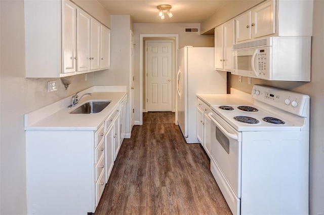 kitchen featuring white appliances, visible vents, dark wood finished floors, white cabinetry, and a sink