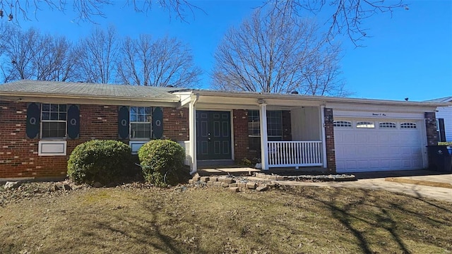 single story home with a garage, covered porch, brick siding, and driveway