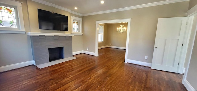 unfurnished living room with wood finished floors, ornamental molding, a fireplace with flush hearth, and baseboards