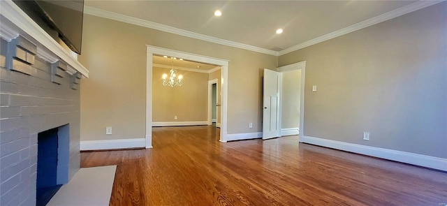 unfurnished living room featuring a fireplace, wood finished floors, baseboards, ornamental molding, and an inviting chandelier