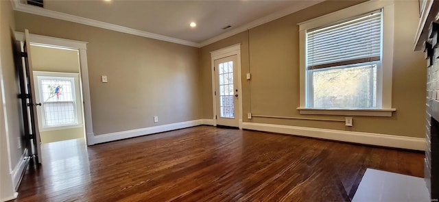 entryway featuring dark wood-style floors, recessed lighting, baseboard heating, ornamental molding, and baseboards