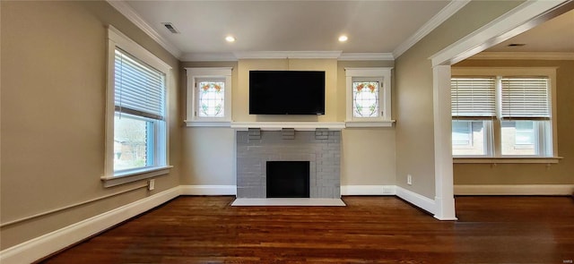 unfurnished living room featuring baseboards, a fireplace, wood finished floors, and crown molding