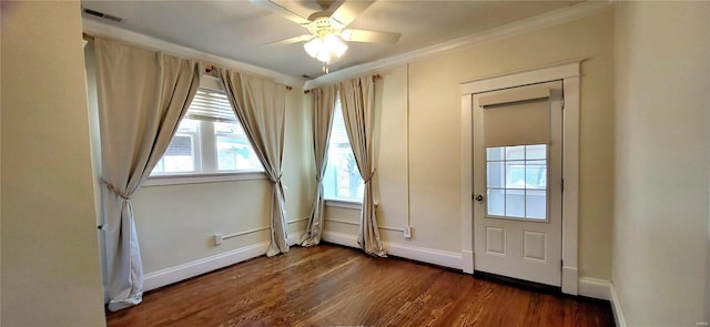 interior space featuring ornamental molding, a ceiling fan, baseboards, and wood finished floors