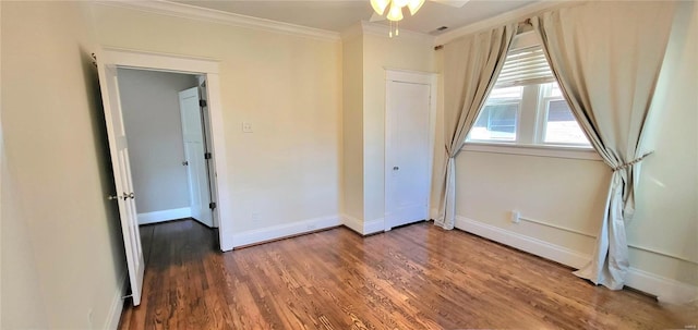 unfurnished bedroom featuring baseboards, ornamental molding, and wood finished floors