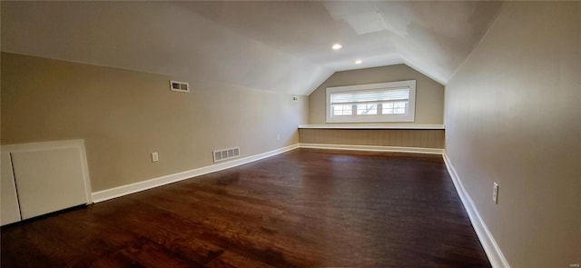 bonus room with lofted ceiling, baseboards, visible vents, and dark wood-type flooring