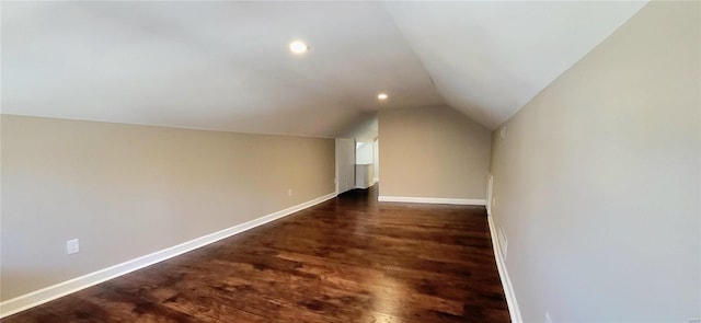 additional living space featuring vaulted ceiling, recessed lighting, dark wood-style floors, and baseboards