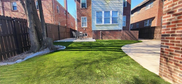 view of yard featuring a patio area and a fenced backyard