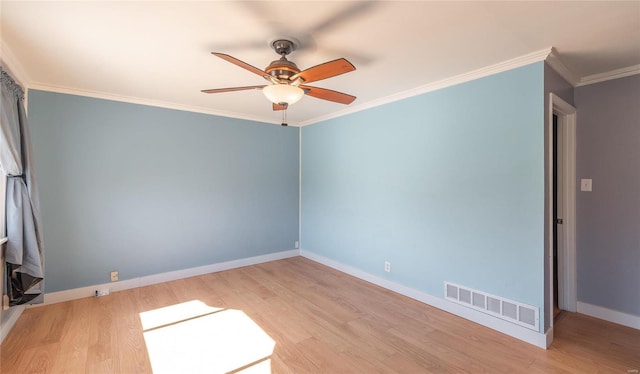 empty room featuring a ceiling fan, light wood-style flooring, visible vents, and baseboards