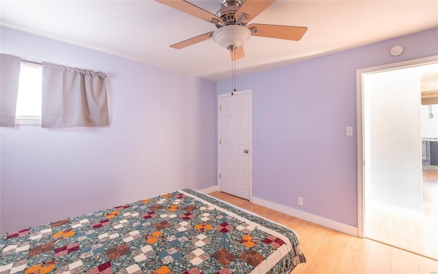 unfurnished bedroom with light wood-style flooring, baseboards, and ceiling fan