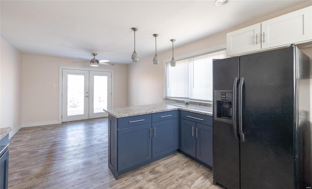 kitchen featuring light wood finished floors, white cabinets, a peninsula, french doors, and black fridge