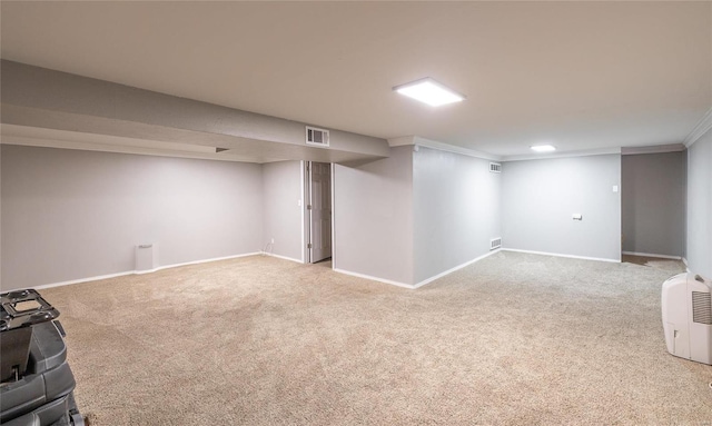 finished below grade area with carpet flooring, crown molding, and baseboards